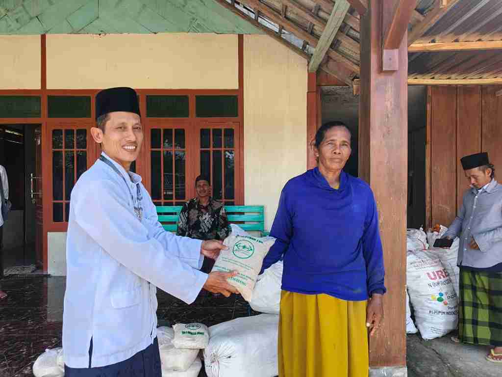 Petugas LAZISNU Temayang menyerahkan zakat fitrah berupa beras kepada warga di akhir Ramadhan 1447 H